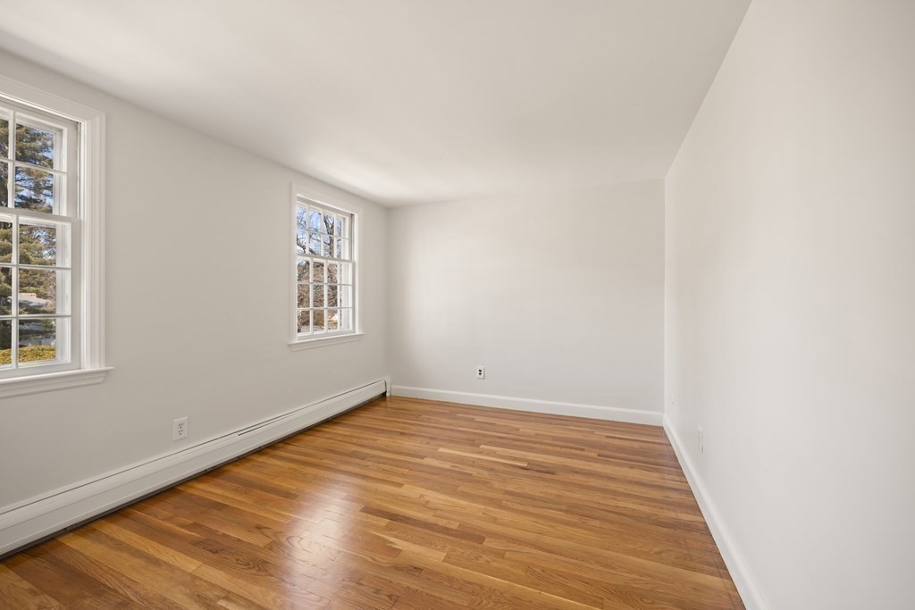 8 Juniper Place Lexington, MA 02420 - Photo 24 of 42 an empty room with wooden floor and windows