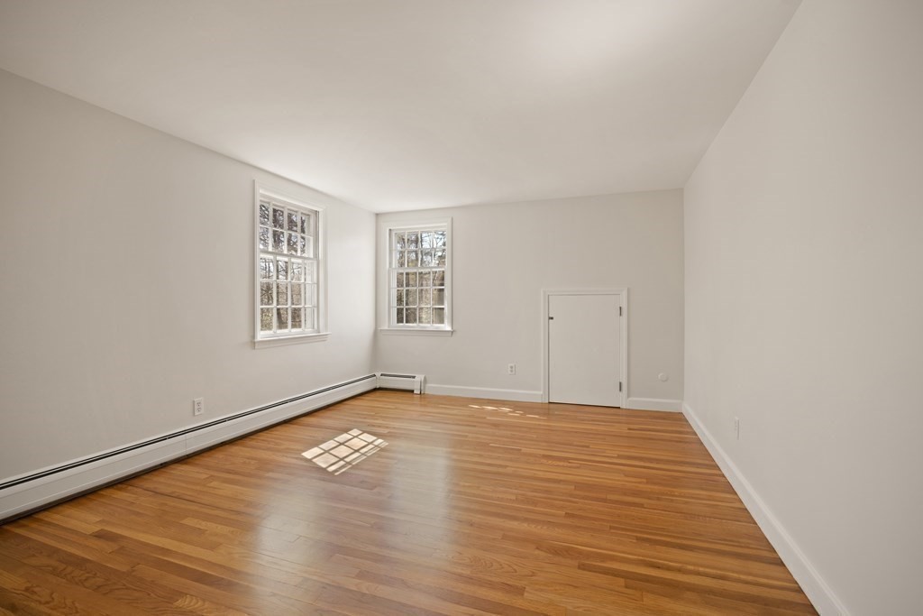 8 Juniper Place Lexington, MA 02420 - Photo 26 of 42 an empty room with wooden floor and windows