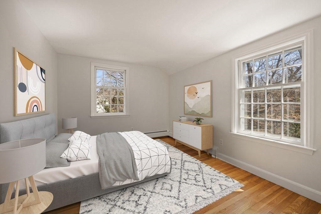8 Juniper Place Lexington, MA 02420 - Photo 29 of 42 a bedroom with a bed and wooden floor