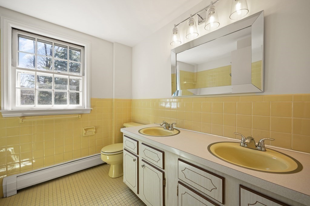 8 Juniper Place Lexington, MA 02420 - Photo 31 of 42 a bathroom with a sink a toilet and mirror