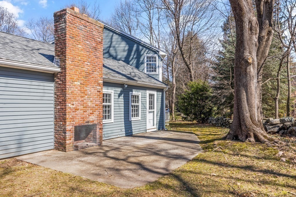 8 Juniper Place Lexington, MA 02420 - Photo 37 of 42 a front view of a house with a garden