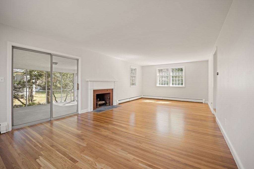 8 Juniper Place Lexington, MA 02420 - Photo 5 of 42 a view of empty room with wooden floor and fireplace