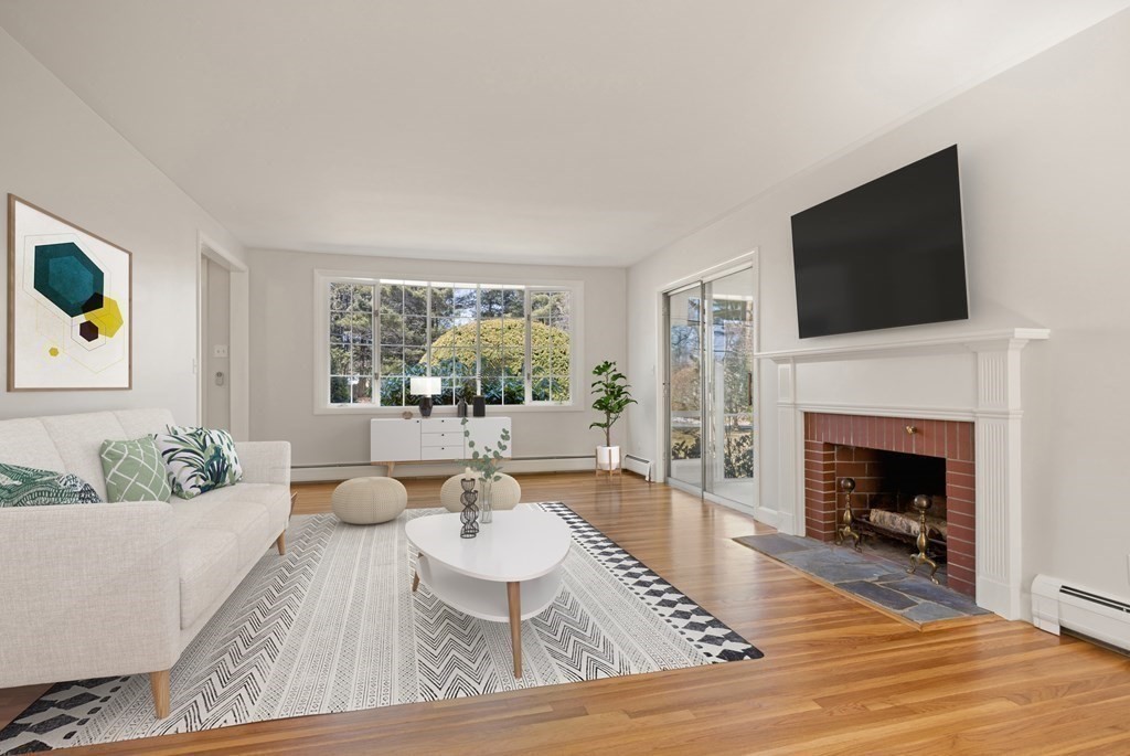 8 Juniper Place Lexington, MA 02420 - Photo 6 of 42 a living room with furniture a flat screen tv and a fireplace