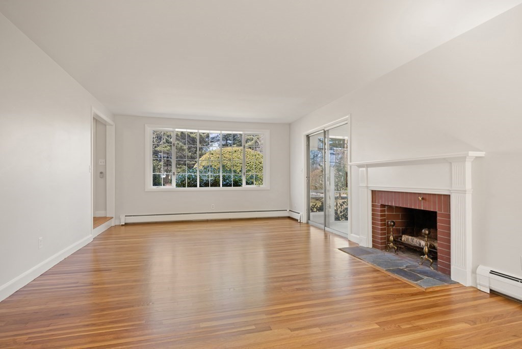 8 Juniper Place Lexington, MA 02420 - Photo 7 of 42 a view of an empty room with wooden floor fireplace and a window
