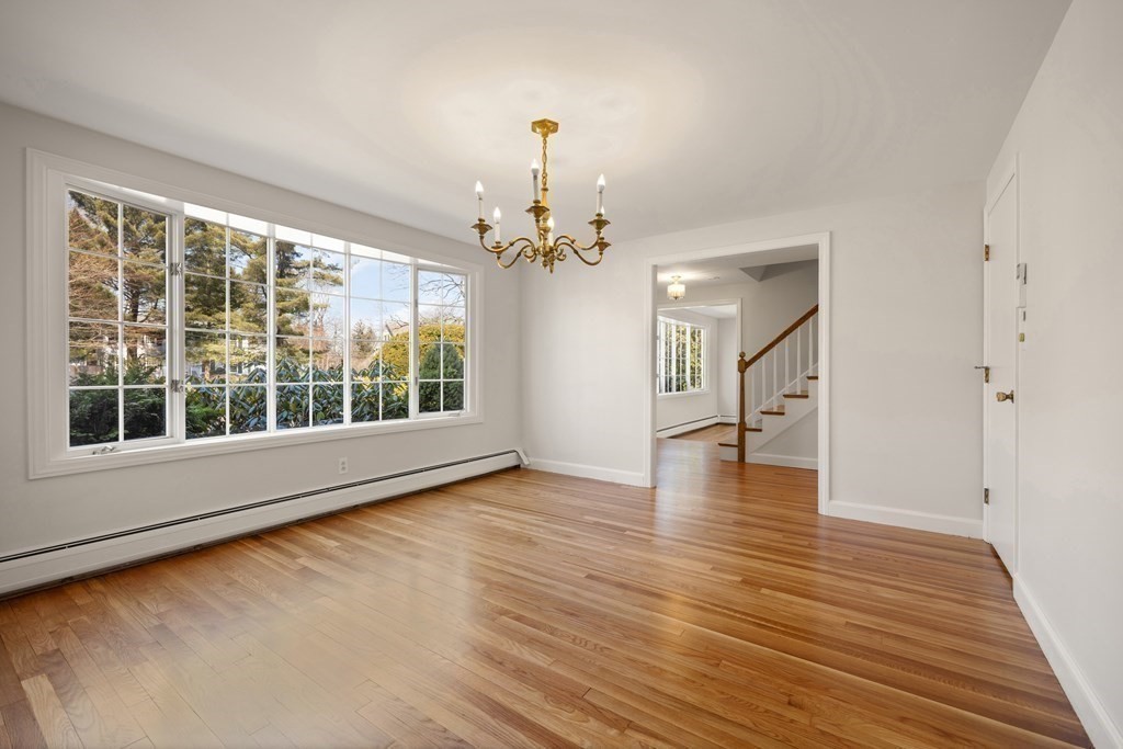 8 Juniper Place Lexington, MA 02420 - Photo 9 of 42 a view of an empty room with wooden floor and a window