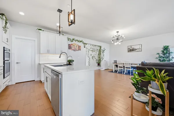 a kitchen with furniture a chandelier a stove and a chandelier
