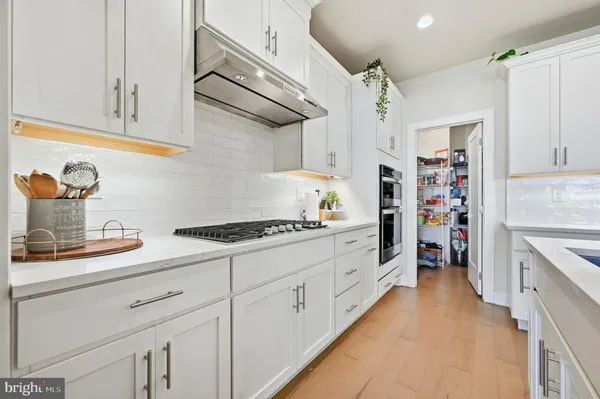 a kitchen with stainless steel appliances granite countertop a stove and a sink