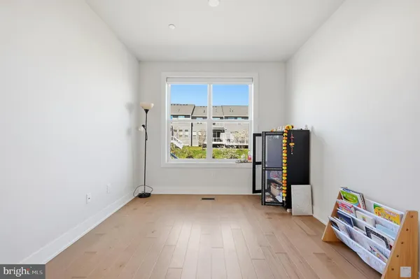 a view of room with window and wooden floor