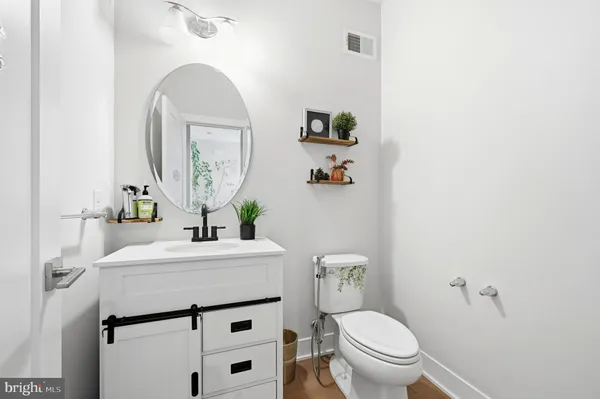 a bathroom with a sink toilet and mirror