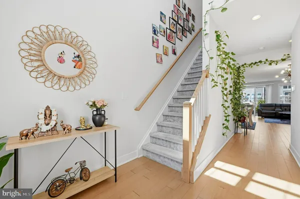 a view of a hallway with entryway wooden floor and front door