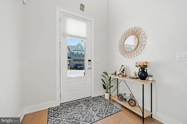 a living room with table and a mirror
