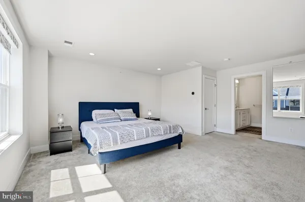 a spacious bedroom with a bed and a window