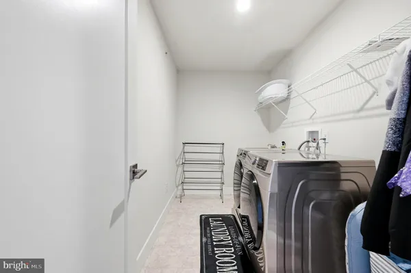 a view of walk in closet with clothes
