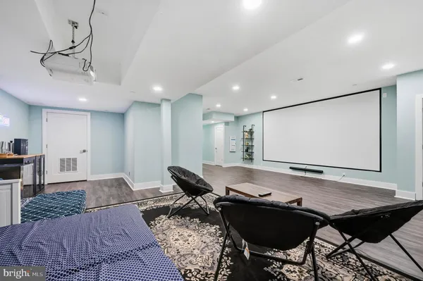 a living room with furniture pool table and a flat screen tv