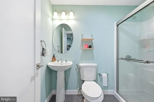 a bathroom with a sink mirror and toilet