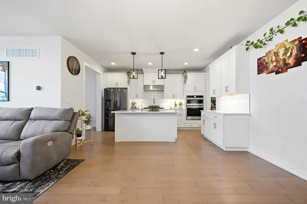 a living room with kitchen island furniture and a kitchen