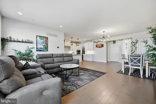 a living room with furniture and kitchen view