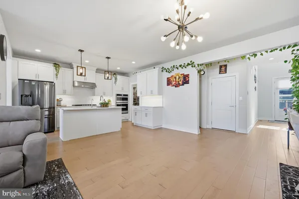a view of kitchen with furniture and refrigerator