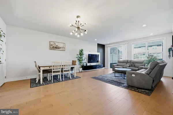 a living room with furniture a large window and a table