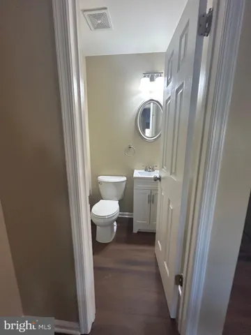 a bathroom with a toilet and a mirror