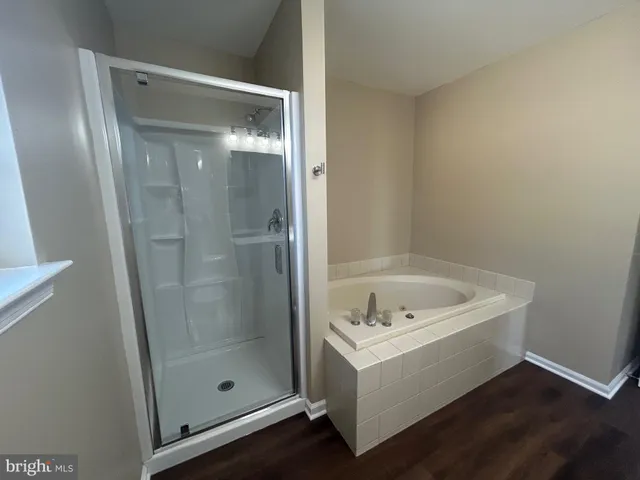 a bathroom with a tub and shower
