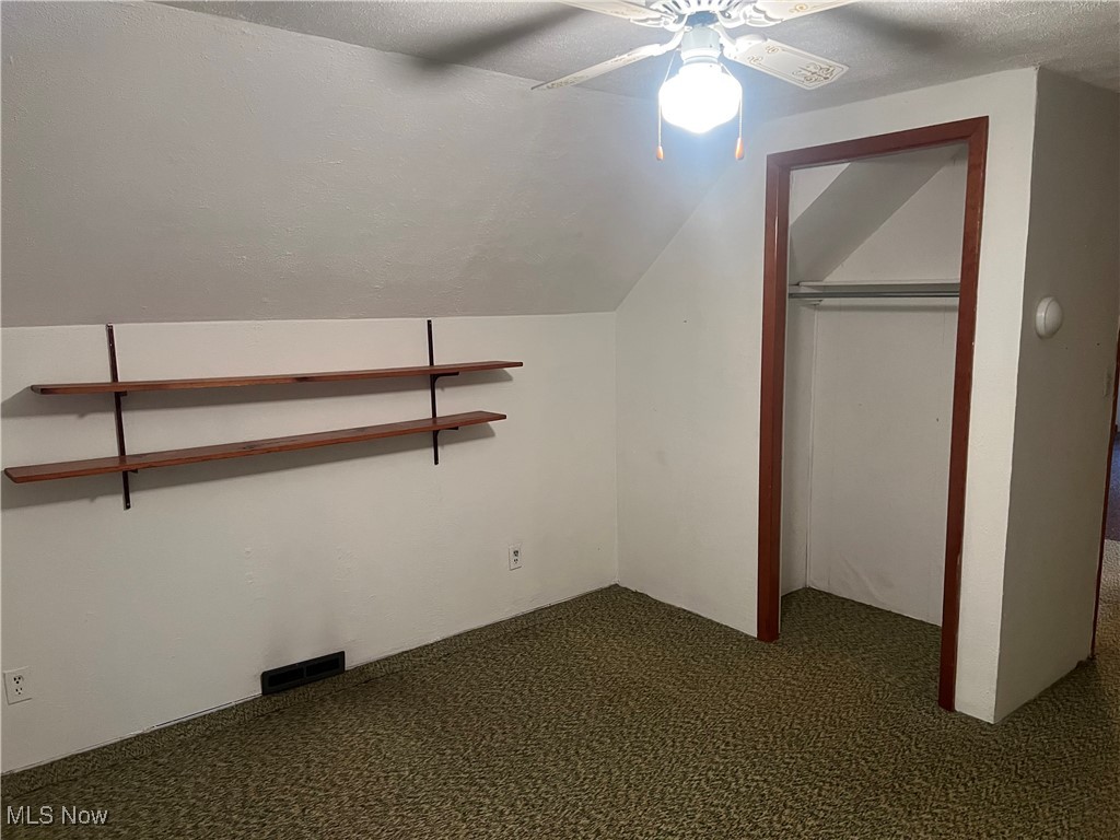 7296 Poore Road Conneaut, OH 44030 - Photo 18 of 27 Bedroom upstairs with carpet floors, vaulted a textured ceiling, and ceiling fan
