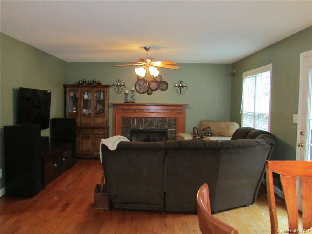 423 Maple Ridge Circle Salisbury, NC 28147 - Photo 3 of 21 a living room with furniture a fireplace and a flat screen tv