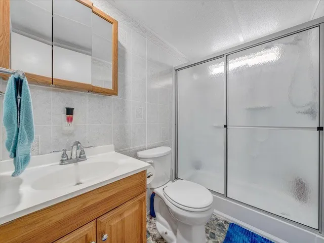 a kitchen with stainless steel appliances granite countertop a sink cabinets and wooden floor