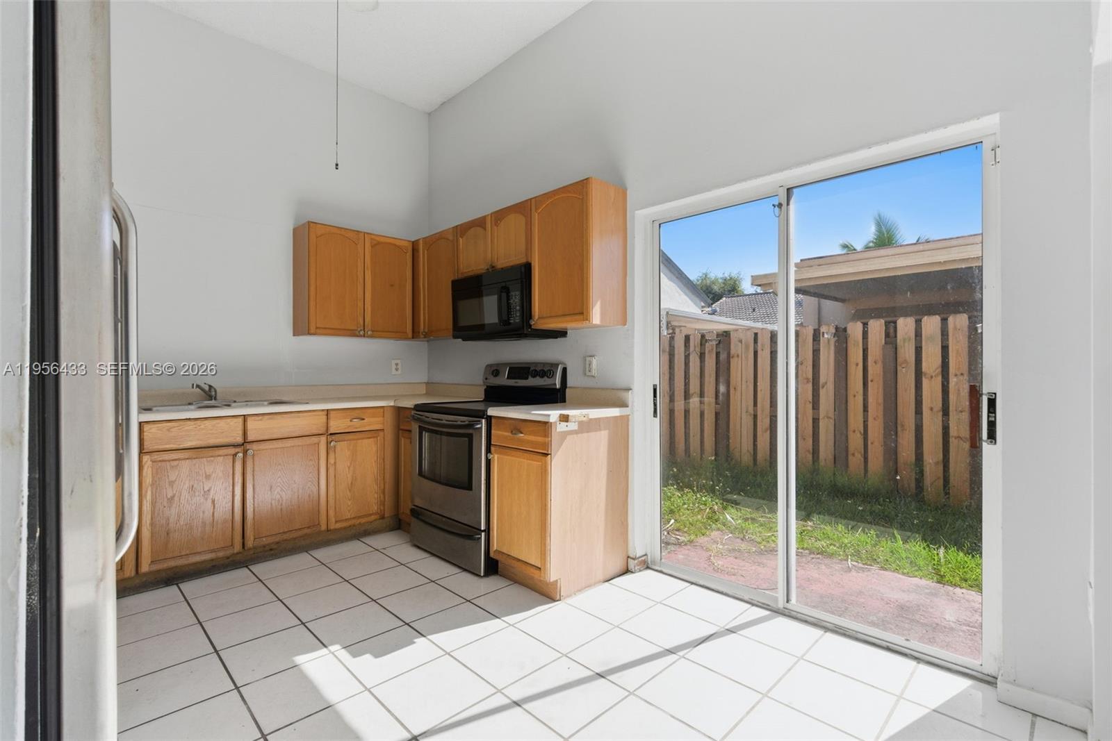 15804 Southwest 112th Terrace Miami, FL 33196 - Photo 17 of 46 a kitchen with appliances cabinets and a sink