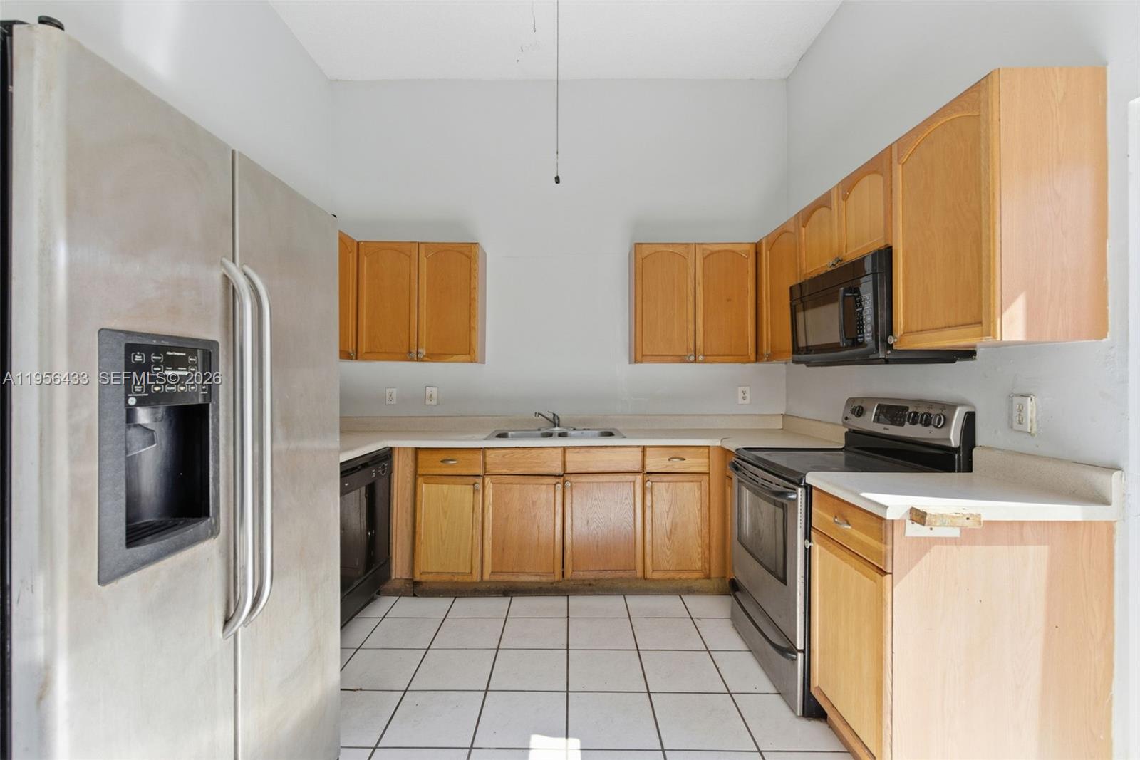 15804 Southwest 112th Terrace Miami, FL 33196 - Photo 18 of 46 a kitchen with stainless steel appliances granite countertop a stove a sink and a microwave