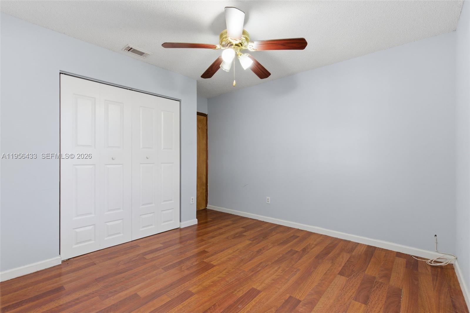 15804 Southwest 112th Terrace Miami, FL 33196 - Photo 25 of 46 a view of an empty room with wooden floor