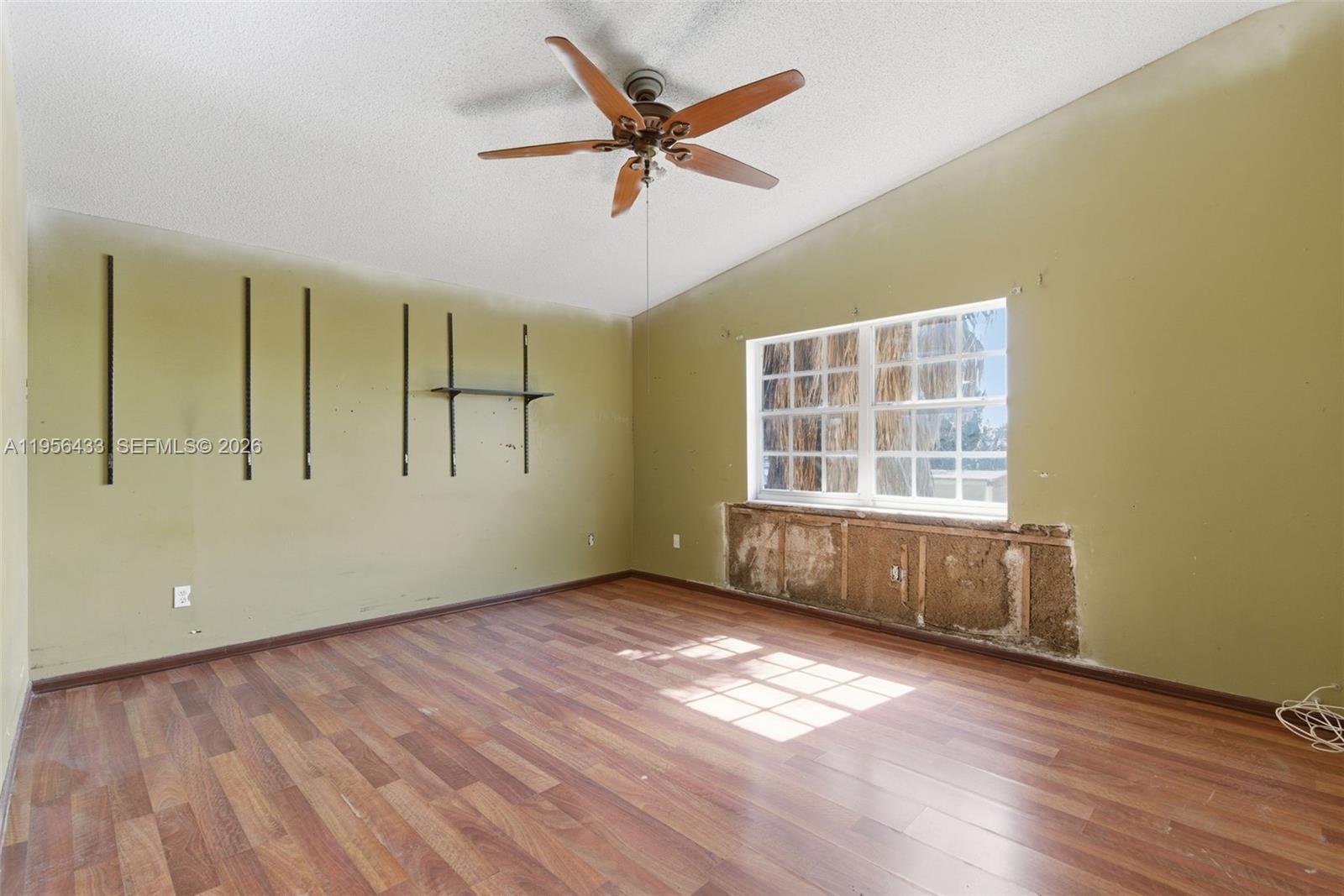15804 Southwest 112th Terrace Miami, FL 33196 - Photo 27 of 46 wooden floor in an empty room with a window