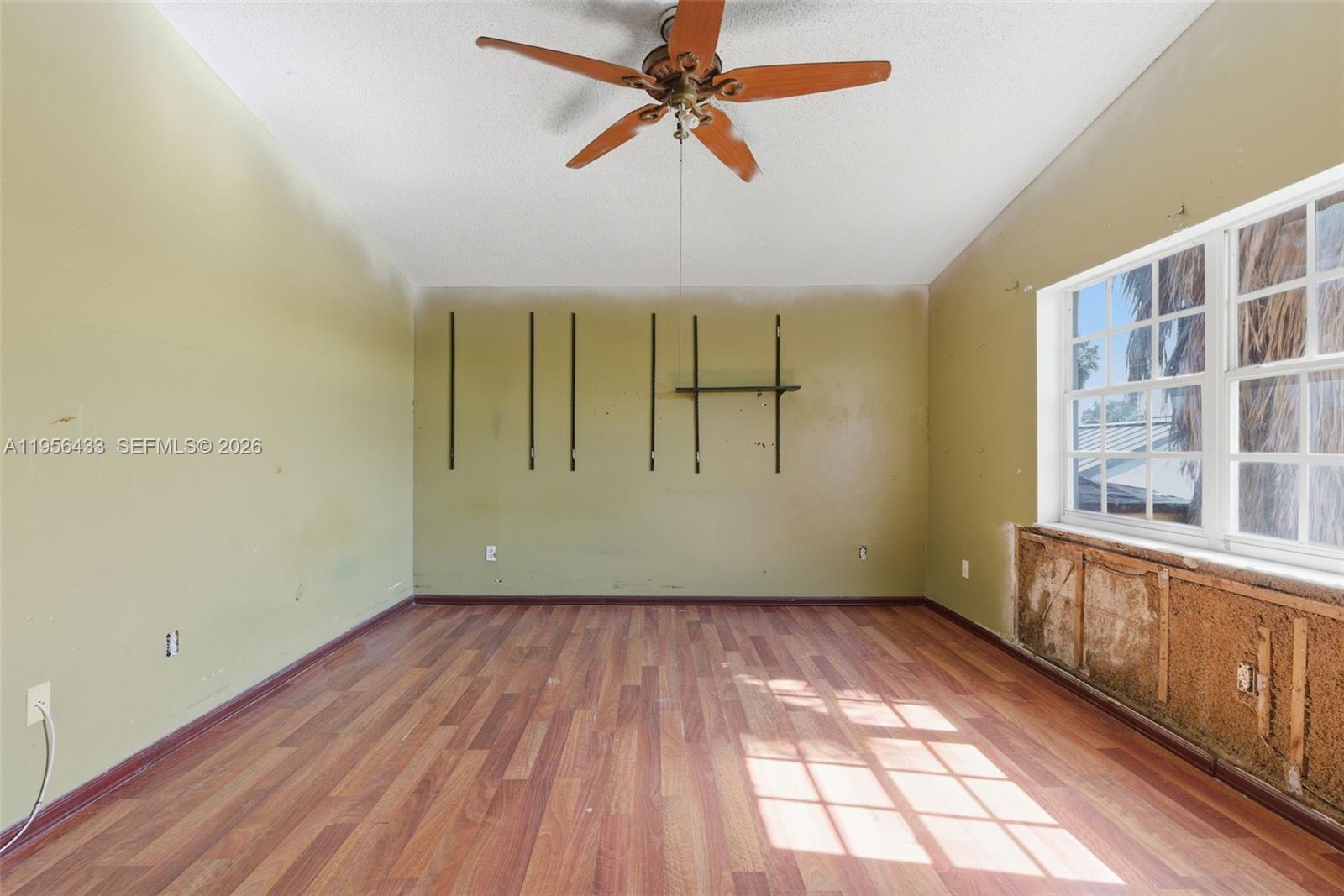 15804 Southwest 112th Terrace Miami, FL 33196 - Photo 28 of 46 a view of empty room with wooden floor and fan