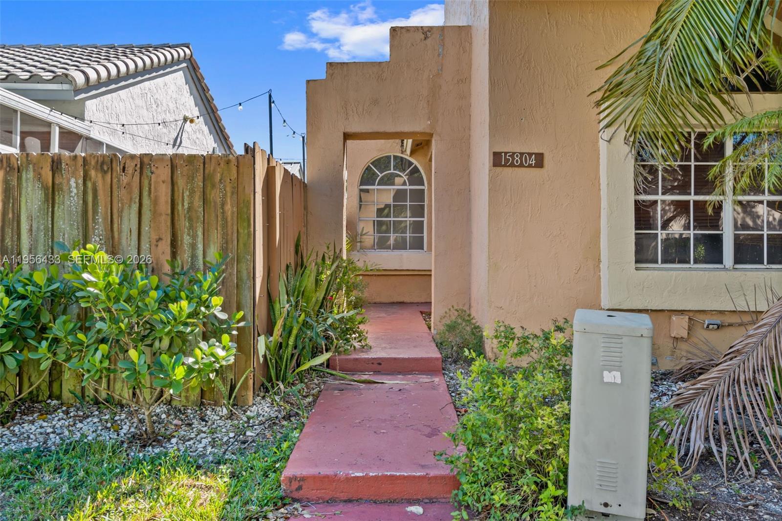 15804 Southwest 112th Terrace Miami, FL 33196 - Photo 3 of 46 a couple of flower plants in front of door