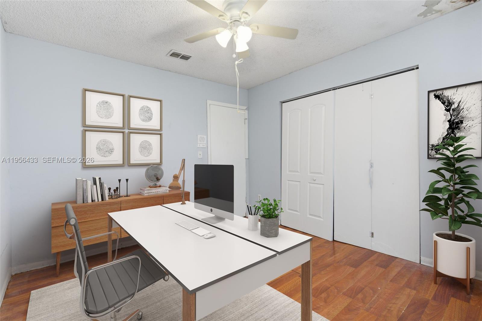 15804 Southwest 112th Terrace Miami, FL 33196 - Photo 37 of 46 a view of a workspace with furniture and a potted plant