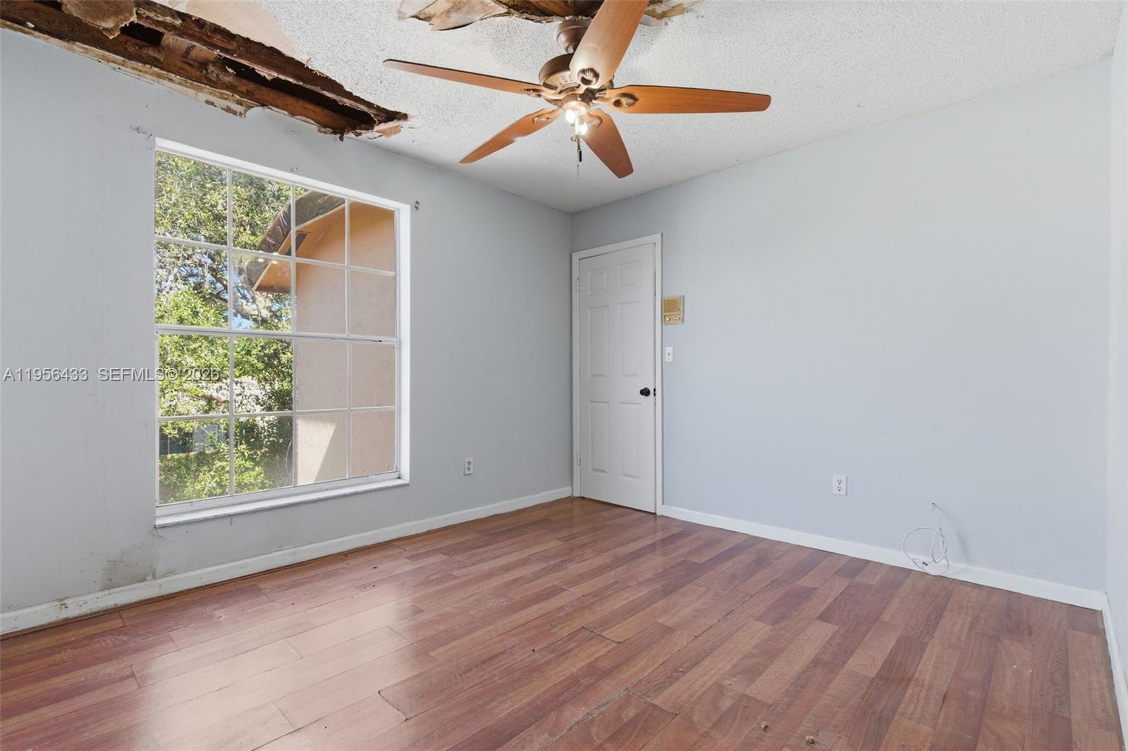 15804 Southwest 112th Terrace Miami, FL 33196 - Photo 41 of 46 an empty room with windows and fan