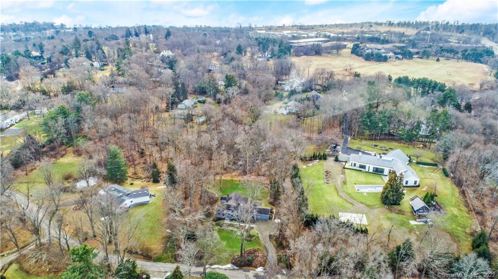 an aerial view of house with yard swimming pool and outdoor seating