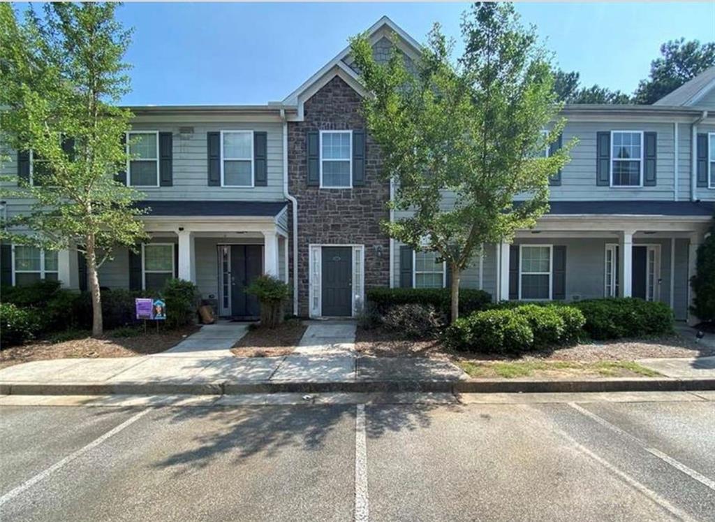 585 McWilliams Road Southeast, Unit 2301 Atlanta, GA 30315 - Photo 11 of 15 a front view of a house with a yard and potted plants