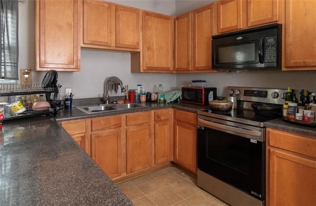 585 McWilliams Road Southeast, Unit 2301 Atlanta, GA 30315 - Photo 3 of 15 a kitchen with stainless steel appliances granite countertop a stove a sink dishwasher and a microwave