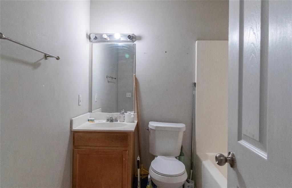 585 McWilliams Road Southeast, Unit 2301 Atlanta, GA 30315 - Photo 7 of 15 a bathroom with a toilet a sink and shower