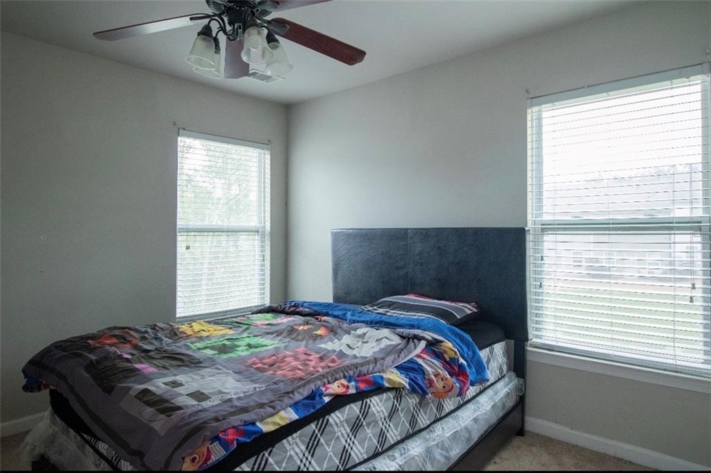 585 McWilliams Road Southeast, Unit 2301 Atlanta, GA 30315 - Photo 8 of 15 a bedroom with a bed and a window