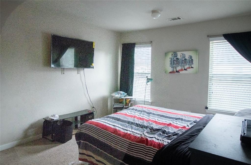 585 McWilliams Road Southeast, Unit 2301 Atlanta, GA 30315 - Photo 10 of 15 a bedroom with a bed and a flat screen tv