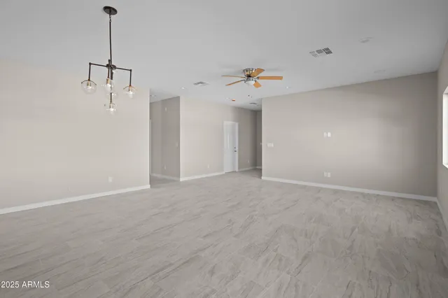 a view of an empty room with a fan