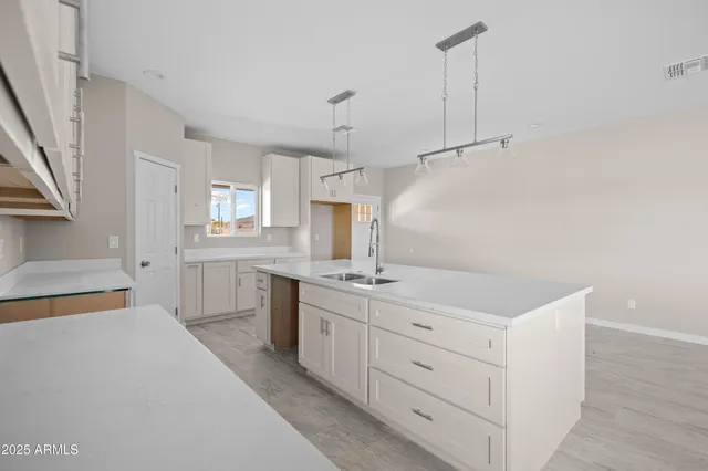 a kitchen with a sink a stove and cabinets