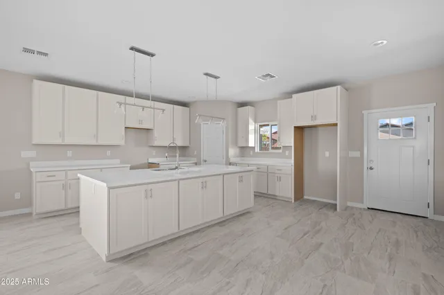 a kitchen with cabinets and stainless steel appliances