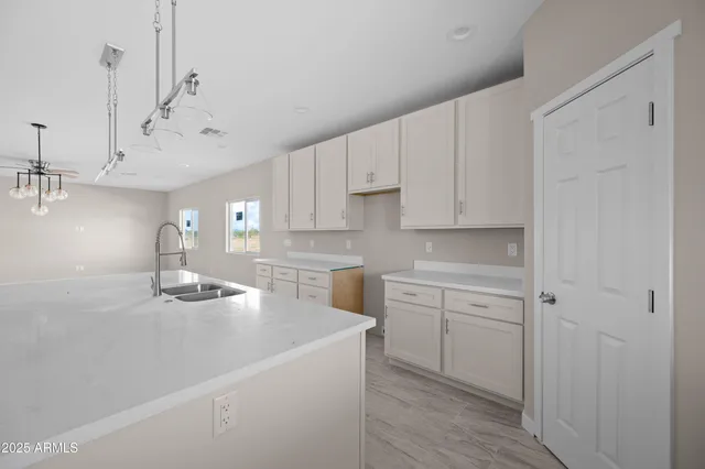 a kitchen with cabinets a sink and appliances