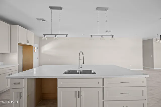 a kitchen with a sink and cabinets