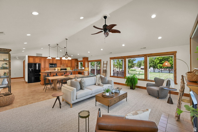 13658 South Fort Street Draper, UT 84020 - Photo 12 of 87 Expansive living area featuring vaulted ceilings, recessed lighting, and wood-finish window frames