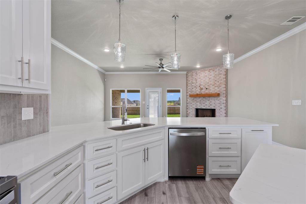 1341 Promised Land Road Hewitt, TX 76643 - Photo 11 of 29 Spacious kitchen featuring white cabinetry, light-toned countertops, and a stainless steel dishwasher