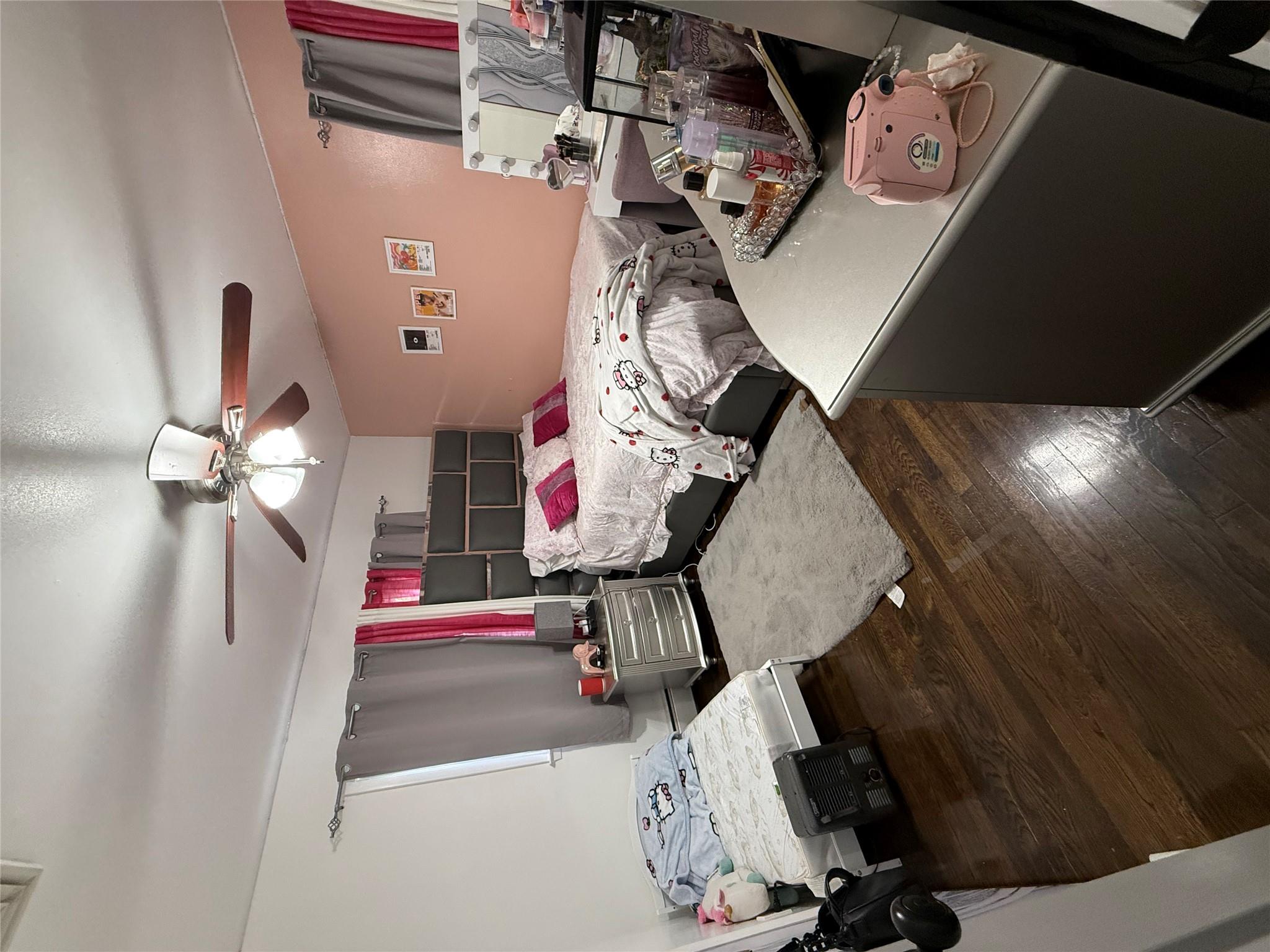77 Upper Road Middletown, NY 10940 - Photo 13 of 18 Bedroom featuring wood finished floors, ceiling fan, and a baseboard radiator